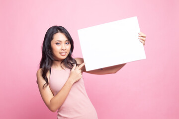 Young Asian woman point to  blank sign.