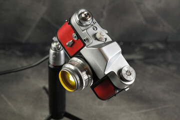 A vintage lamp made by me from an old film camera on a gray cement background.