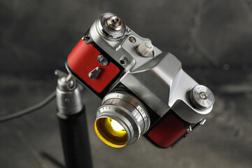 A vintage lamp made by me from an old film camera on a gray cement background.