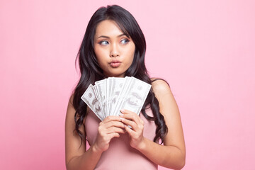 Portrait of  young asian woman  showing bunch of money banknotes.