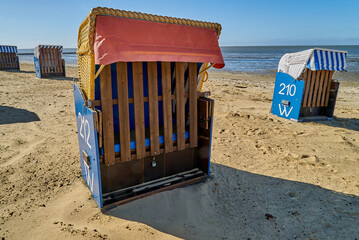 close up of beach chairs on empty beach in Cuxhaven-Döse (Germany) during Corona (Covid 19) lock down in April 2020 on a bright sunny day with blue sky