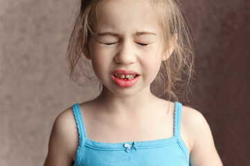 a child experiencing discomfort and pain from losing a baby tooth