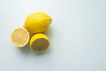 group of lemons isolated on a white table. cut lemon. view from above