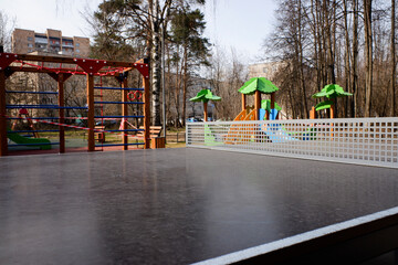 Ping pong table with children's playground on background