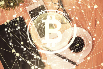 Double exposure of blockchain theme hologram over table with phone. Top view. Crypto technology concept.