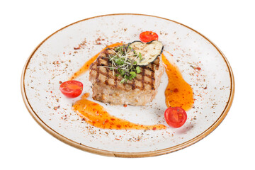 Pork steak served on a plate with sauce and microgreens. Isolated on a white background.