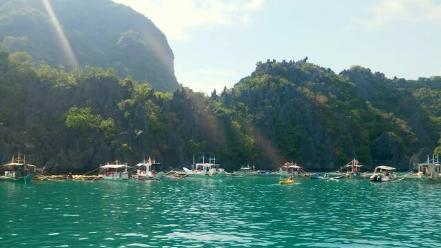 A beautiful bay with turquoise water and small boats in the Philippines