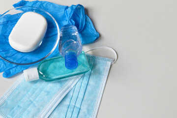 Covid-19 prevention concept background, rubber gloves, hand sanitizer, surgical masks and antibacterial soap isolated on white background, medical backdrop