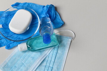 Covid-19 prevention concept background, rubber gloves, hand sanitizer, surgical masks and antibacterial soap isolated on white background, medical backdrop