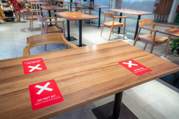 Social distancing rules one table per person in practice, alternate seating in local public food...