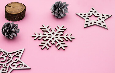 Christmas and New Year. Pink flat lay frame with snowflakes, Christmas toys and cones. Copy space.