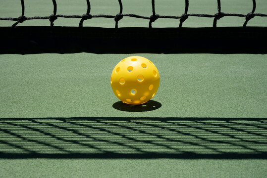 Pickleball On Court Near Net with Shadows