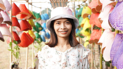 portrait Asian women wearing patterned clothes, happy to travel, pink hats, smiling, seeing braces. 