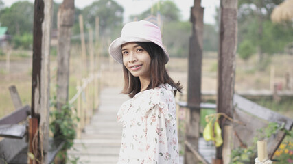 Naklejka premium portrait Asian women wearing patterned clothes, happy to travel, pink hats, smiling, seeing braces. 