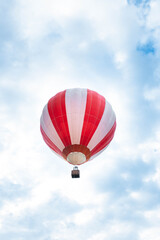 Balloon in the blue sky. Red balloon in the blue cloudy sky.