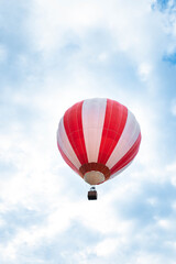 Balloon in the blue sky. Red balloon in the blue cloudy sky.