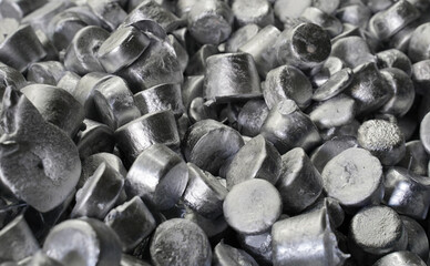 Lots of shiny aluminum ingots at a recycling plant
