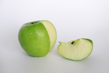 Delicious green Apple with a cut out slice
