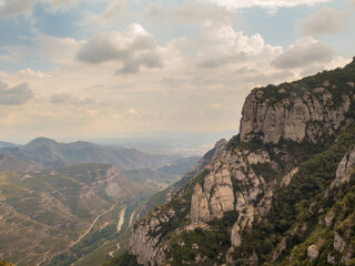 Fototapeta na wymiar Montserrat, Barcelona / Spain - Sept. 8, 2016: The dramatic mountain of Montserrat, famous for its wind-sculpted rock formations and Benedictine abbey,