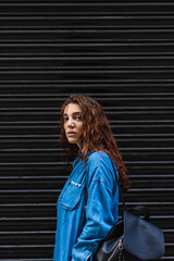 Beautiful young woman on the street. Black background