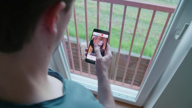 Man on smartphone dating app like all girls over shoulder view 4K