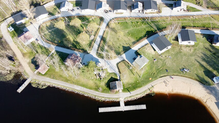 Aerial view of the lake Borisovskoye, the forest and the settlement in autumn day, Borisovo,...