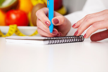 Diet concept, nutritionist makes a plan of proper nutrition