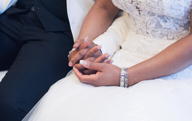 Black bride and groom hold hands