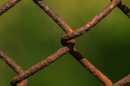 Rusted metal fance weave close up