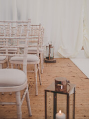 Wedding aisle with Chiavari chairs and candle lanterns