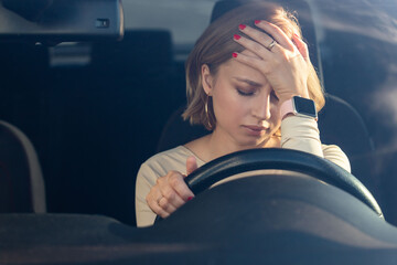 Depressed woman driver sitting in her car, feeling emotional burnout after work. Chronic fatigue  