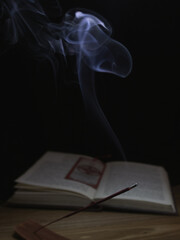 incense smoke and open book