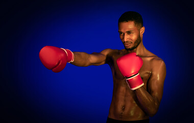 African American Boxer Boxing Wearing Gloves Standing Over Blue Background