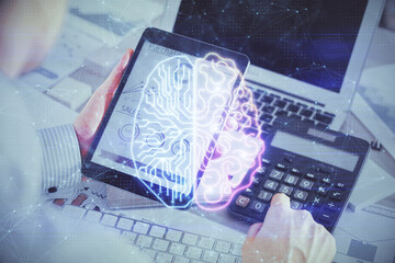 Double exposure of man's hand holding and using a digital device and brain hologram drawing. Data concept.