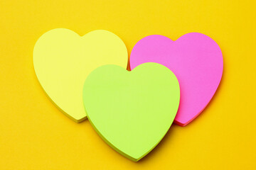 Three blank heart shaped stickers with space for text. Creative symbolic background