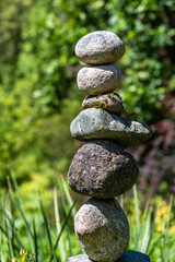 Fototapeta na wymiar Stacked rocks in a garden, meditation focus for wellness 