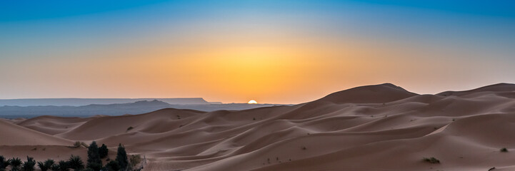 Fototapeta na wymiar Merzouga in the Sahara Desert in Morocco. Web banner in panoramic view.