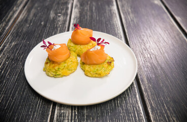 Light small portion of snack with red fish on the plate