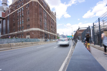 Cars on FDR Drive along East River and bikers, joggers
