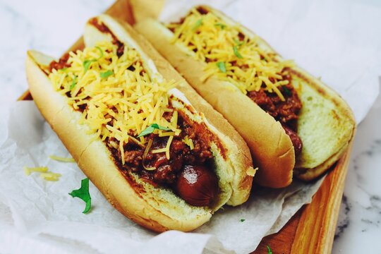 Homemade Chili Dogs Topped With Cheddar Cheese, Selective Focus