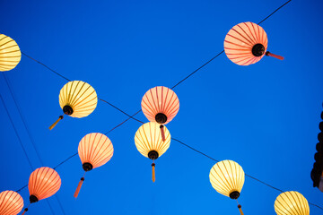 lanterns hanging against the sky in hoi an, vietnam