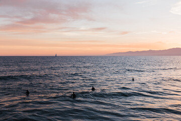 Fototapeta na wymiar surfers waiting for waves at sunset on California coast