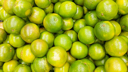 Fruit brackground. Fruits in the supermarket. Tropical fruit. Orange background