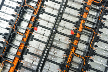  Selective focus of Electric car lithium battery pack and wiring connections internal between cells on background. - obrazy, fototapety, plakaty