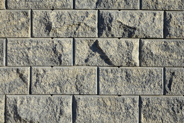 stone background texture of a gray wall imitating brick closeup