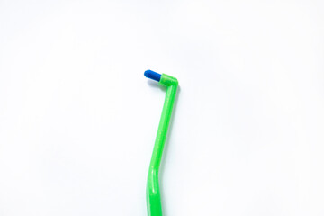 Green toothbrush with a single beam for braces on a white background