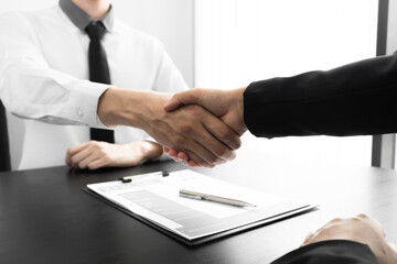 Job seeker and the company owner making handshake in the office room