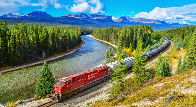 ALBERTA, CANADA - October 1,2017: Long freight train Canadian Pacific Railway (CPR) moving along Bow river in Canadian Rockies ,Banff National Park, Canadian Rockies,Canada.