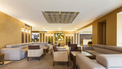 Interior lobby of modern hotel with big gray sofas