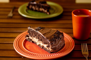 Two pieces of chocolate cake with chocolate icing and chocolate filling
